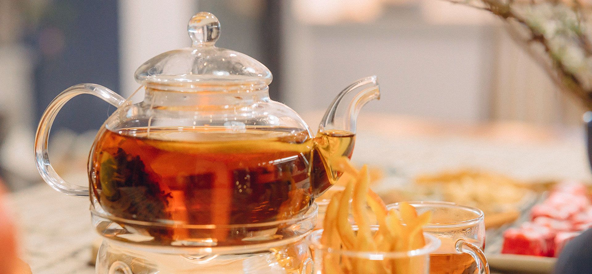 Glass Teapot Filled With Black Tea.